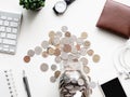 Saving money concept with smartphone, notebook, keyboard, wallet and coins stack on white table background. Royalty Free Stock Photo