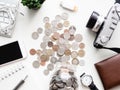 Saving money concept with smartphone, notebook, keyboard, wallet and coins stack on white table background. Royalty Free Stock Photo