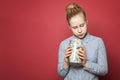 Saving money. Cute teen girl holding jar with money cash