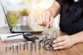 Saving money and finances concept, hand woman hand put coins in jug glass with Calculate with a calculator Royalty Free Stock Photo