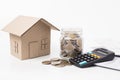 Saving money and finances concept ,home model and coin money with calculator on awhite background Royalty Free Stock Photo