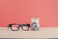 Saving money concept,coins in glass jar over red background