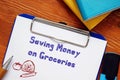 Saving Money On Groceries inscription on the sheet Royalty Free Stock Photo