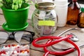 Saving money for health care insurance - money glass, stethoscope, pills and bottles Royalty Free Stock Photo