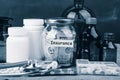 Saving money for health care insurance - money glass, stethoscope, pills and bottles Royalty Free Stock Photo