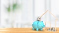 The Blue piggy bank and wood home icon 3d rendering Royalty Free Stock Photo