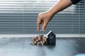 Saving money for house and real estate. Woman hand protecting on stack coins and house model on table Royalty Free Stock Photo