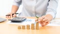 Saving money and investment concept, Business accountant woman stacking coins into increasing columns stack for budget behind desk Royalty Free Stock Photo