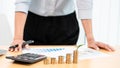 Saving money and investment concept, Business accountant woman stacking coins into increasing columns stack for budget behind desk Royalty Free Stock Photo