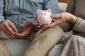 Saving money investment for future. Senior adult mature couple hands holding piggy bank with money coin. Old man woman Royalty Free Stock Photo