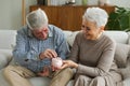 Saving money investment for future. Senior adult mature couple holding piggy bank putting money coin. Old man woman Royalty Free Stock Photo