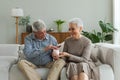 Saving money investment for future. Senior adult mature couple holding piggy bank putting money coin. Old man woman Royalty Free Stock Photo