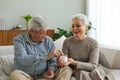 Saving money investment for future. Senior adult mature couple holding piggy bank putting money coin. Old man woman Royalty Free Stock Photo