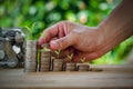 Saving money.Male hand stack coins and a jar of money to shown growing concept business, wealthy, education, house and loan Royalty Free Stock Photo