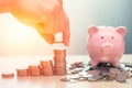 Saving Money to pig bank, Piggy Bank with stack of coin Royalty Free Stock Photo