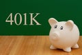 Saving money for retirement 401k with a piggy bank on a desk Royalty Free Stock Photo