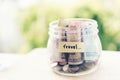 Saving money for travel jar concept. Money box on empty table collect banknote and coins for holiday trip budget Royalty Free Stock Photo