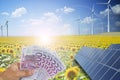 Saving money using green energy from photovoltaic solar panels and wind turbines Royalty Free Stock Photo