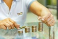 Saving money, woman stacking coins into increasing columns Royalty Free Stock Photo