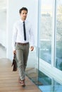 Saving the planet one step at a time. A handsome young businessman walking with his suitcase. Royalty Free Stock Photo