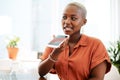 Saving some voice notes to listen to later. a young businesswoman talking on a cellphone in an office.