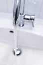 Saving water: Close up of spigot with clear, flowing water Royalty Free Stock Photo
