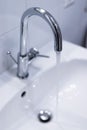 Saving water: Close up of spigot with clear, flowing water Royalty Free Stock Photo