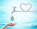 Saving water concept with faucet pipe in heart love shape. Element of this image furnished by NASA
