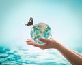 Saving water, world water day, environmental ecology protection, earth day concept with woman`s hand holding green planet Royalty Free Stock Photo