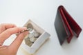 Saving your money concept - woman put coin from wallet in a box for economical lives Royalty Free Stock Photo