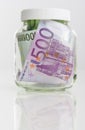 Savings Concept: Bundle of European Currency Banknotes Put in Jar Royalty Free Stock Photo