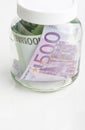 Savings Concept: Bundle of European Currency Banknotes Put in Jar Royalty Free Stock Photo