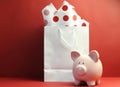 Savings concept with white shopping bag, red polka dot tissue paper Royalty Free Stock Photo