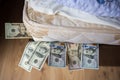 Savings in dolars, under bed mattress Royalty Free Stock Photo