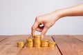 Savings, female hand stacking gold coins