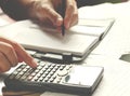 Savings, finances, economy and home concept - close up of man with calculator counting making notes at home Royalty Free Stock Photo