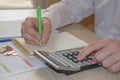 Savings, finances, economy and home concept - close up of man with calculator counting money and making notes Royalty Free Stock Photo