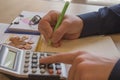 Savings, finances, economy and home concept - close up of man with calculator counting money and making notes Royalty Free Stock Photo