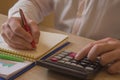 Savings, finances, economy and home concept - close up of man with calculator counting money and making notes Royalty Free Stock Photo