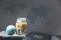 Savings jars full of money and globe with Holy Bible for mission, Mission christian idea. bible and book on wooden table, Royalty Free Stock Photo