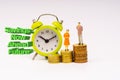 SAVINGS NOW AHEAD FUTURE inscription written, alarm clock, coins and businessman miniature