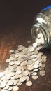 Savings overflow Coins with a car label spill on table