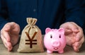 Savings are protected. Protect piggy bank and chinese yuan or japanese yen money bag. Safety of investments. Retirement money fund Royalty Free Stock Photo