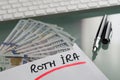 Savings for retirement concept with Roth Ira written on white envelope with cash US dollars Royalty Free Stock Photo