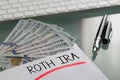 Savings for retirement concept with Roth Ira written on white envelope with cash US dollars Royalty Free Stock Photo