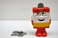 savings vault. Savings vinyl doll mascot style safe with the motive of saving coins and money, with a coin