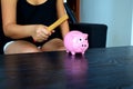 Woman is going to break a piggy bank with a hammer. Royalty Free Stock Photo