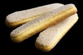 Savoiardi italian sponge biscuits isolated on black. Royalty Free Stock Photo