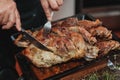 Savor the Flavor: Intimate Views of Skilled Hands Carving Juicy Lamb Roast in The Kitchen