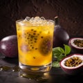 Glass of sweet and tangy passion fruit drink with fresh passion fruit on a table Royalty Free Stock Photo